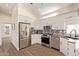 This kitchen features stainless steel appliances, a stylish backsplash, and wood flooring at 632 Aero Rd, Mesa, AZ 85205