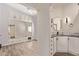 Main bedroom leading into a bathroom with a mirrored vanity and updated fixtures at 632 Aero Rd, Mesa, AZ 85205