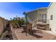 Enjoy outdoor living on this charming patio with stone pavers, seating, and a grill, perfect for relaxation and entertaining at 632 Aero Rd, Mesa, AZ 85205