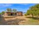 View of the backyard with mature tree and lattice covered area at 6405 N 46Th Dr, Glendale, AZ 85301