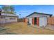 View of the backyard with mature trees, lawn, and storage sheds at 6405 N 46Th Dr, Glendale, AZ 85301