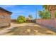 View of the backyard with block wall, lattice accents, tree, and lawn at 6405 N 46Th Dr, Glendale, AZ 85301