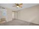 Neutral bedroom with plush carpet, ceiling fan, and ample closet space for a comfortable and serene retreat at 6405 N 46Th Dr, Glendale, AZ 85301