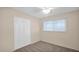 Bright bedroom featuring neutral walls, carpet, a window, closet and a ceiling fan at 6405 N 46Th Dr, Glendale, AZ 85301