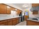 Classic kitchen featuring wood cabinetry, stainless steel appliances, and bright countertops for a functional cooking space at 6405 N 46Th Dr, Glendale, AZ 85301