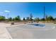 Community basketball court with blue key, bright lighting, and shaded picnic area on a sunny day at 6494 W Matilda Ln, Glendale, AZ 85308