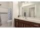 Bathroom with neutral-toned walls, a combination shower and tub, and dark wood vanity at 6494 W Matilda Ln, Glendale, AZ 85308