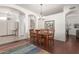 Well-lit dining room featuring wood floors, plantation shutters, and a modern chandelier at 6494 W Matilda Ln, Glendale, AZ 85308