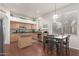 Well-lit kitchen with stainless appliances, an island, and an adjacent dining area at 6494 W Matilda Ln, Glendale, AZ 85308