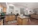 Bright kitchen with stainless steel appliances, an island, and an open layout to the living room at 6494 W Matilda Ln, Glendale, AZ 85308