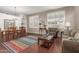 Bright living room with hardwood floors, neutral walls, white shutters, and plush sofa and chair at 6494 W Matilda Ln, Glendale, AZ 85308