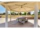 Park picnic pavilion with concrete table and seating, overlooking the community sand volleyball court at 6494 W Matilda Ln, Glendale, AZ 85308