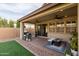 A covered patio with backyard barbecue area featuring an outdoor seating set at 6926 W Spur Dr, Peoria, AZ 85383