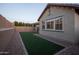 A well-kept backyard with artificial turf and decorative stone, perfect for outdoor relaxation at 6926 W Spur Dr, Peoria, AZ 85383