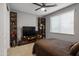 Well-lit bedroom with a ceiling fan, window, and organized shelving unit at 6926 W Spur Dr, Peoria, AZ 85383