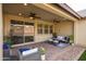 This spacious covered patio features ample seating and a ceiling fan at 6926 W Spur Dr, Peoria, AZ 85383