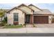 Charming single-story home featuring a brick driveway, two car garage and welcoming front entryway at 6926 W Spur Dr, Peoria, AZ 85383