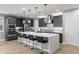 Modern kitchen with stainless appliances, white quartz countertop island, and gray cabinets at 6926 W Spur Dr, Peoria, AZ 85383