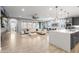 Open-concept living area with wood-look tile flooring, a ceiling fan, and a gourmet kitchen at 6926 W Spur Dr, Peoria, AZ 85383