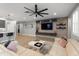 Bright living room featuring wood-look tile floors, an entertainment center, and a comfortable sectional sofa at 6926 W Spur Dr, Peoria, AZ 85383