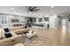 Open-concept living room flows into the kitchen with modern finishes and wood-look tile floors at 6926 W Spur Dr, Peoria, AZ 85383