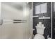 Modern bathroom with glass shower and patterned wallpaper at 7371 W Louise Dr, Glendale, AZ 85310