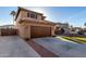 Home with a large driveway leading to an attached two-car garage at 7371 W Louise Dr, Glendale, AZ 85310