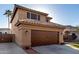 Side view of a home featuring an attached two-car garage and tiled roof at 7371 W Louise Dr, Glendale, AZ 85310