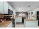 Modern kitchen showcases blue cabinetry, stainless steel appliances, and an open layout at 7371 W Louise Dr, Glendale, AZ 85310