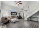 Bright living room with vinyl floors, a ceiling fan, and stairs at 7371 W Louise Dr, Glendale, AZ 85310