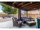 Outdoor patio area features comfortable seating under a wood pergola with ceiling fans at 7371 W Louise Dr, Glendale, AZ 85310