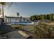 Spacious backyard featuring a charming pool, surrounded by a gravel landscape and green shrubbery at 7819 N 17Th Ave, Phoenix, AZ 85021