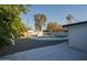 Backyard featuring mature trees, a refreshing swimming pool, and a concrete patio at 7819 N 17Th Ave, Phoenix, AZ 85021