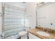 Bathroom with a granite counter, neutral cabinets, and a shower with a striped curtain at 7819 N 17Th Ave, Phoenix, AZ 85021