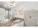 Bathroom showcasing granite counters, neutral tile, shower, and ample lighting at 7819 N 17Th Ave, Phoenix, AZ 85021