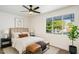 Comfortable bedroom with a ceiling fan, natural lighting, neutral decor and stylish accents at 7819 N 17Th Ave, Phoenix, AZ 85021