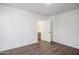 Bedroom with wood-look floors, neutral paint, and an ensuite bath at 7819 N 17Th Ave, Phoenix, AZ 85021