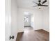 An empty room with wood-look floors, a ceiling fan, and a view of another room at 7819 N 17Th Ave, Phoenix, AZ 85021