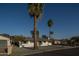 Inviting home with a well-manicured lawn and palm trees creating a welcoming atmosphere at 7819 N 17Th Ave, Phoenix, AZ 85021