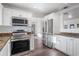 Bright kitchen with stainless steel appliances, including microwave and oven at 7819 N 17Th Ave, Phoenix, AZ 85021