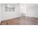 Open living space with wood floors showcasing a view of the updated kitchen at 7819 N 17Th Ave, Phoenix, AZ 85021