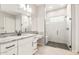 Modern bathroom featuring granite countertops, white cabinets, and a glass-enclosed shower at 7854 W Mockingbird Way, Florence, AZ 85132
