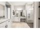 This main bathroom features dual sinks, granite counters, and a walk-in shower with glass doors at 7854 W Mockingbird Way, Florence, AZ 85132