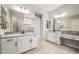 A full bathroom with dual granite countertop sinks and a walk-in shower with frameless glass doors at 7854 W Mockingbird Way, Florence, AZ 85132