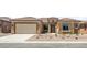 Charming single-story home featuring a tile roof, two-car garage, and desert landscaping at 7854 W Mockingbird Way, Florence, AZ 85132