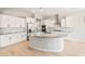 Bright kitchen with white cabinets, stainless steel appliances, and a granite-topped island at 7854 W Mockingbird Way, Florence, AZ 85132