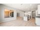 Open-concept living room and kitchen area with light wood floors and modern finishes and light color scheme at 7854 W Mockingbird Way, Florence, AZ 85132