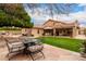 Beautiful backyard with lush artificial grass, and an outdoor seating area at 7866 W Taro Ln, Glendale, AZ 85308