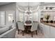 Charming dining area with a bay window, chandelier, and seating for four people at 7866 W Taro Ln, Glendale, AZ 85308