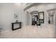 Open foyer featuring neutral tile flooring and paint, an archway to a bedroom, and a view into other living spaces at 7866 W Taro Ln, Glendale, AZ 85308